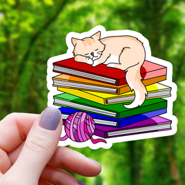 Cat Sleeping on top of Pride Books Sticker - 3"
